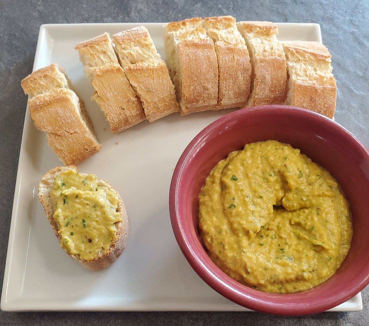 sliced baguette with roasted pepper dip recipe from cleveland cooking