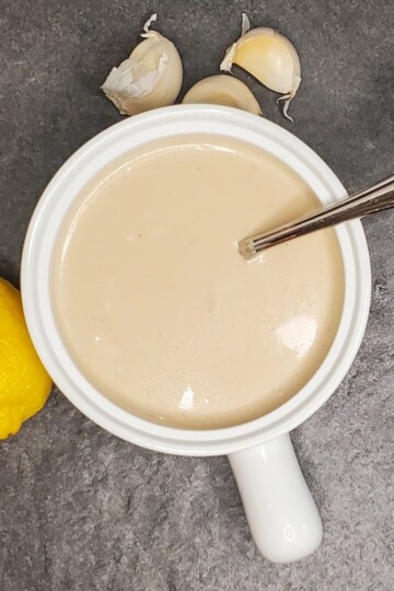 caesar salad dressing from cleveland cooking. Caesar dressing with a lemon and garlic cloves on the counter