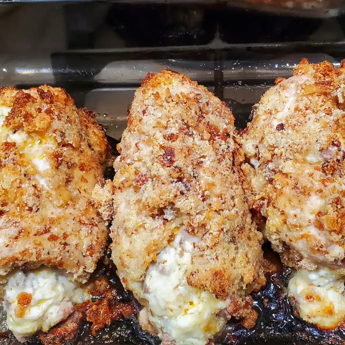 Italian sausage stuffed chicken breasts fresh from the oven. Cleveland cooking. cheese is coming out the front of them.