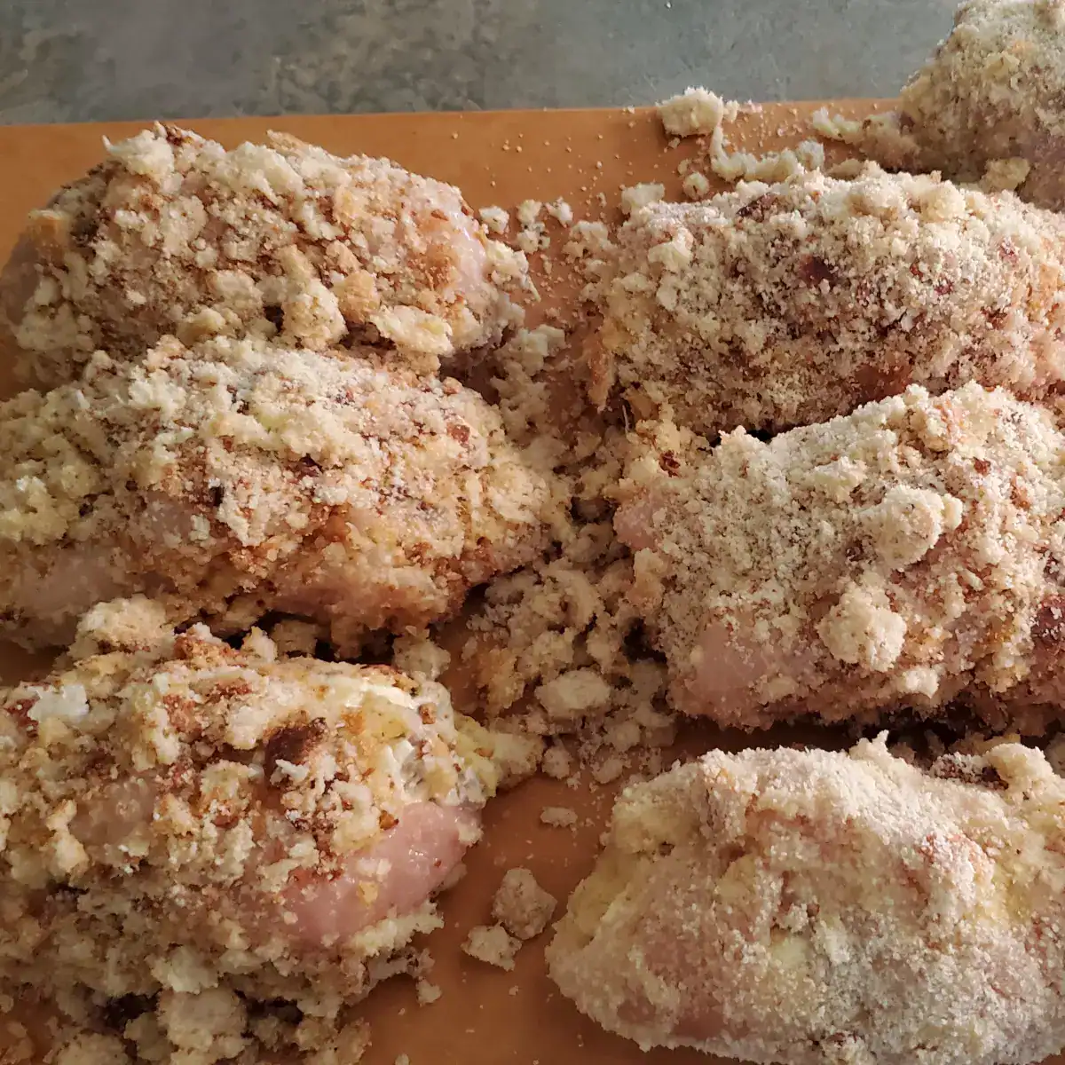 stuffed chicken breast prepared and ready for the oven. Breadcrumbs on the outside of the stuffed chicken breasts.