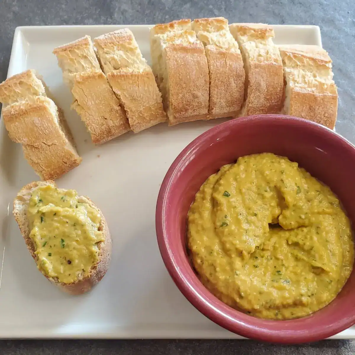 sliced baguette with roasted pepper dip recipe from cleveland cooking