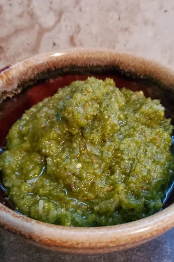 Finished recipe of basil pistachio pesto from cleveland cooking. Pesto consists of parmesan cheese, basil, pistachios, garlic, and olive oil.