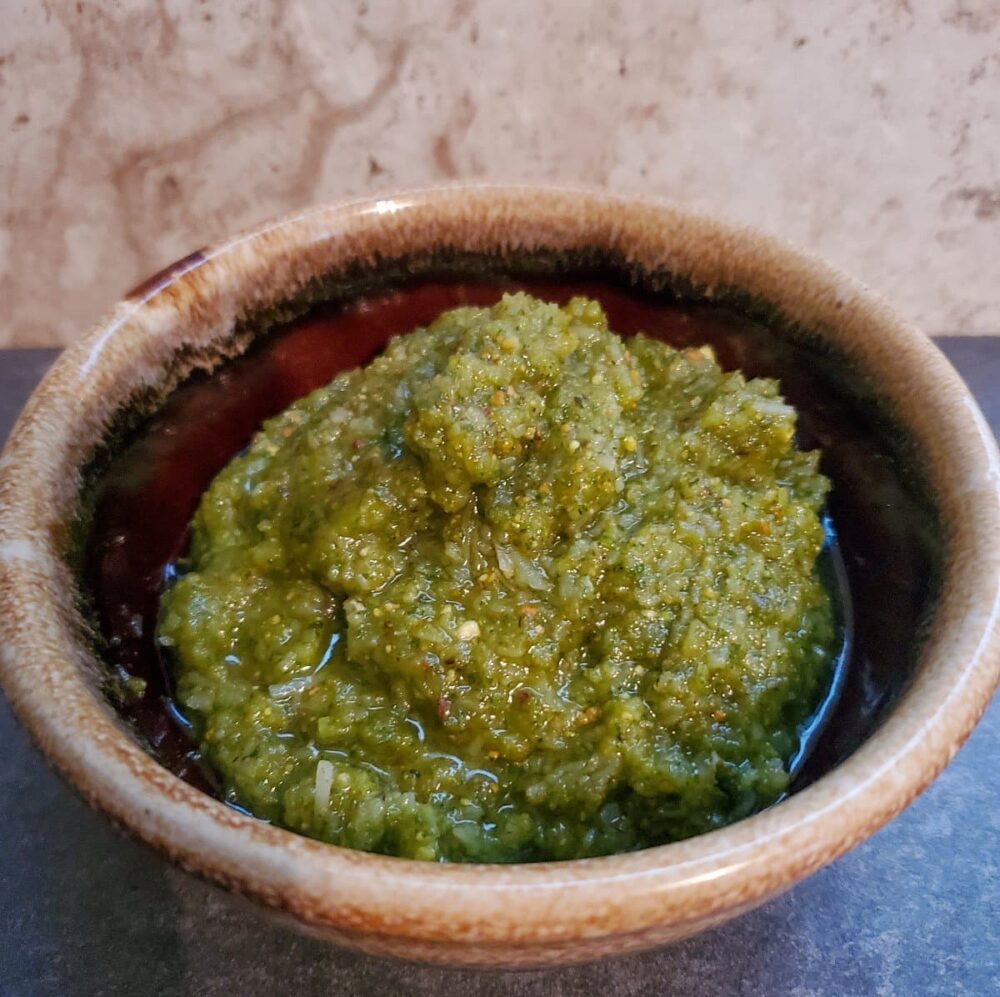 Finished recipe of basil pistachio pesto from cleveland cooking. Pesto consists of parmesan cheese, basil, pistachios, garlic, and olive oil.