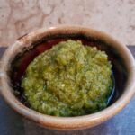 Finished recipe of basil pistachio pesto from cleveland cooking. Pesto consists of parmesan cheese, basil, pistachios, garlic, and olive oil.