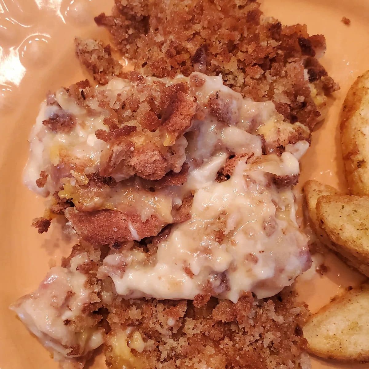 swiss cheese chicken bake from cleveland cooking. chicken layered with a chicken soup sauce, swiss cheese, and seasoned stuffing topping