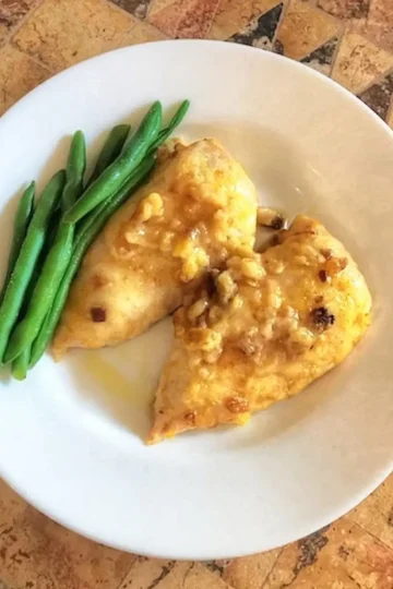 swiss cheese chicken bake with green beans. The chicken has swiss cheese and croutons baked on top. Recipe from cleveland cooking
