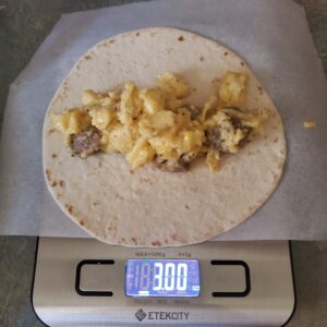 weighing burrito mixture for make ahead breakfast burritos by cleveland cooking