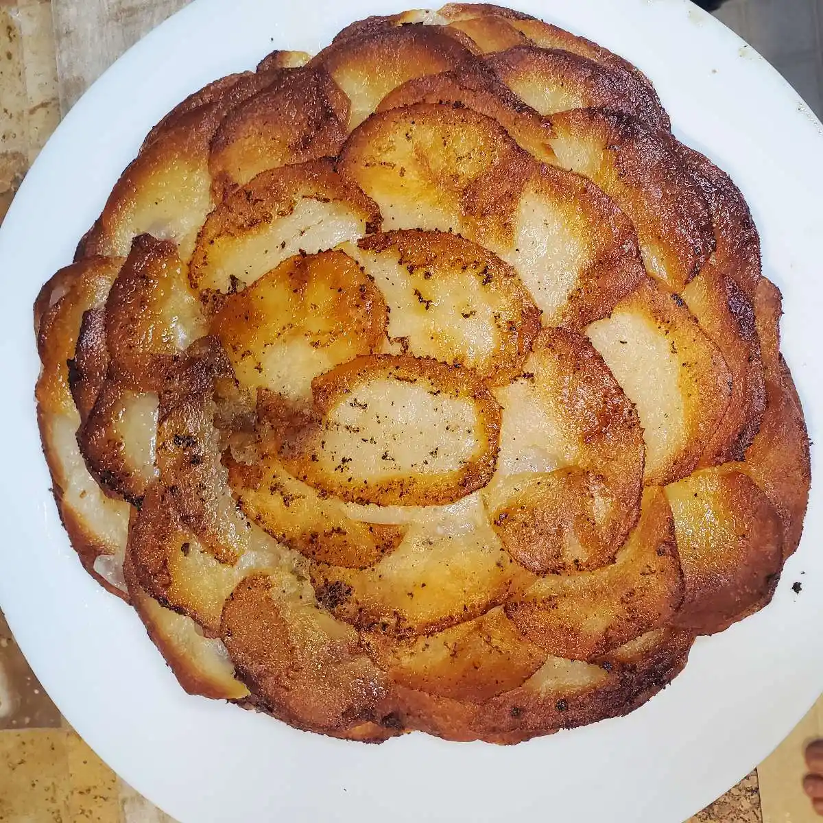 Pommes anna recipe from cleveland cooking. layered potatoes with butter, salt, and pepper.