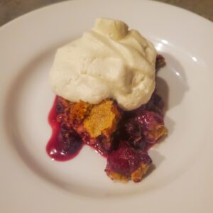 Mixed berry dessert with almond flour topping. A dollop of whipped cream on top. By cleveland cooking