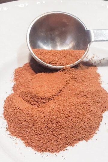 A bit of Vietnamese cinnamon on a plate with a measuring spoon from cleveland cooking