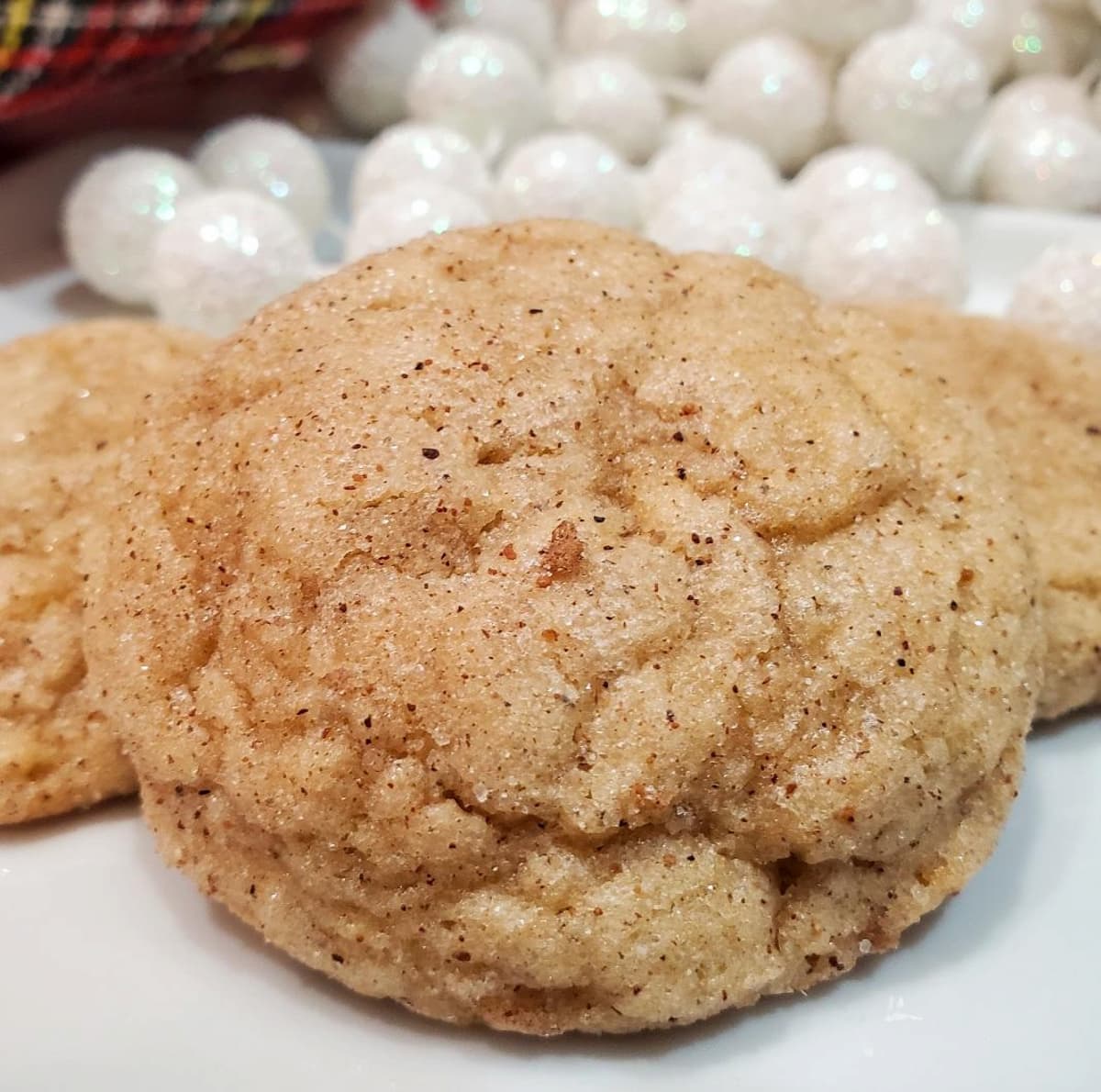 eggnog snickerdoodle cookies from cleveland cooking. Christmas decorations in the background.