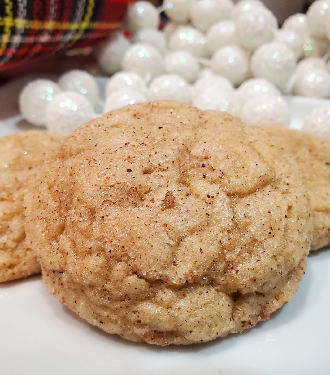 eggnog snickerdoodle cookies from cleveland cooking. Christmas decorations in the background.