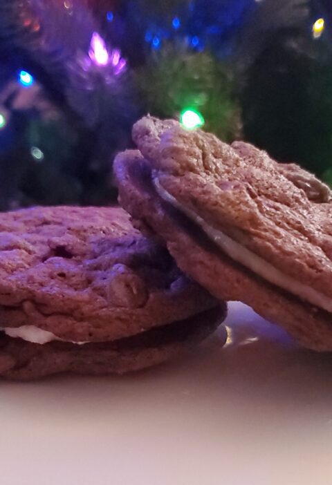 Peppermint chocolate chocolate chip cookie sandwiches from cleveland cooking. cookies with peppermint buttercream in the middle.