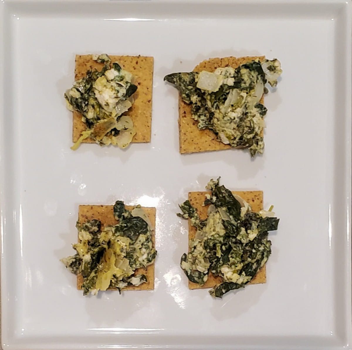 Spanakopita dip on a gluten free cracker from cleveland cooking