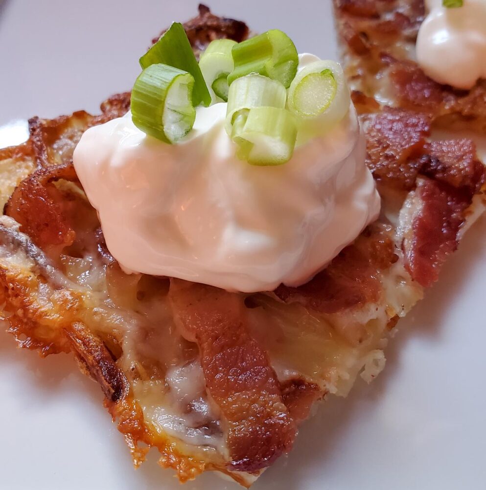 Loaded Hashbrown squares from cleveland cooking. Baked hash browns with cheese, bacon, sour cream, and scallions.