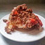 unstuffed cabbage cleveland cooking. layers of onion, beef, sauerkraut, and cabbage.