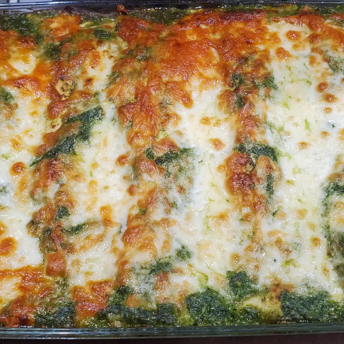 roasted poblano enchiladas Cleveland cooking. chicken enchiladas with a roasted poblano sauce topped with cheese.