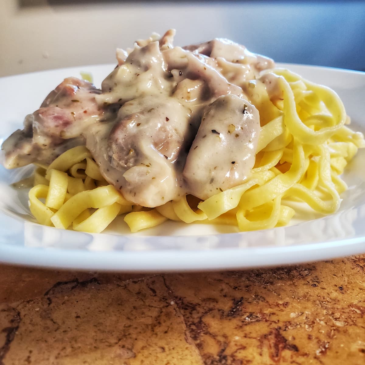 chicken and italian sausage over zucchini noodles with a cottage cheese based alfredo sauce. Recipe from cleveland cooking.