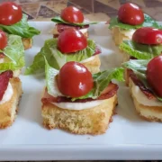 mini BLT appetizers from Cleveland cooking. brioche bread, bacon, lettuce, and tomato. Great for appetizers, parties, and your grazing Table.