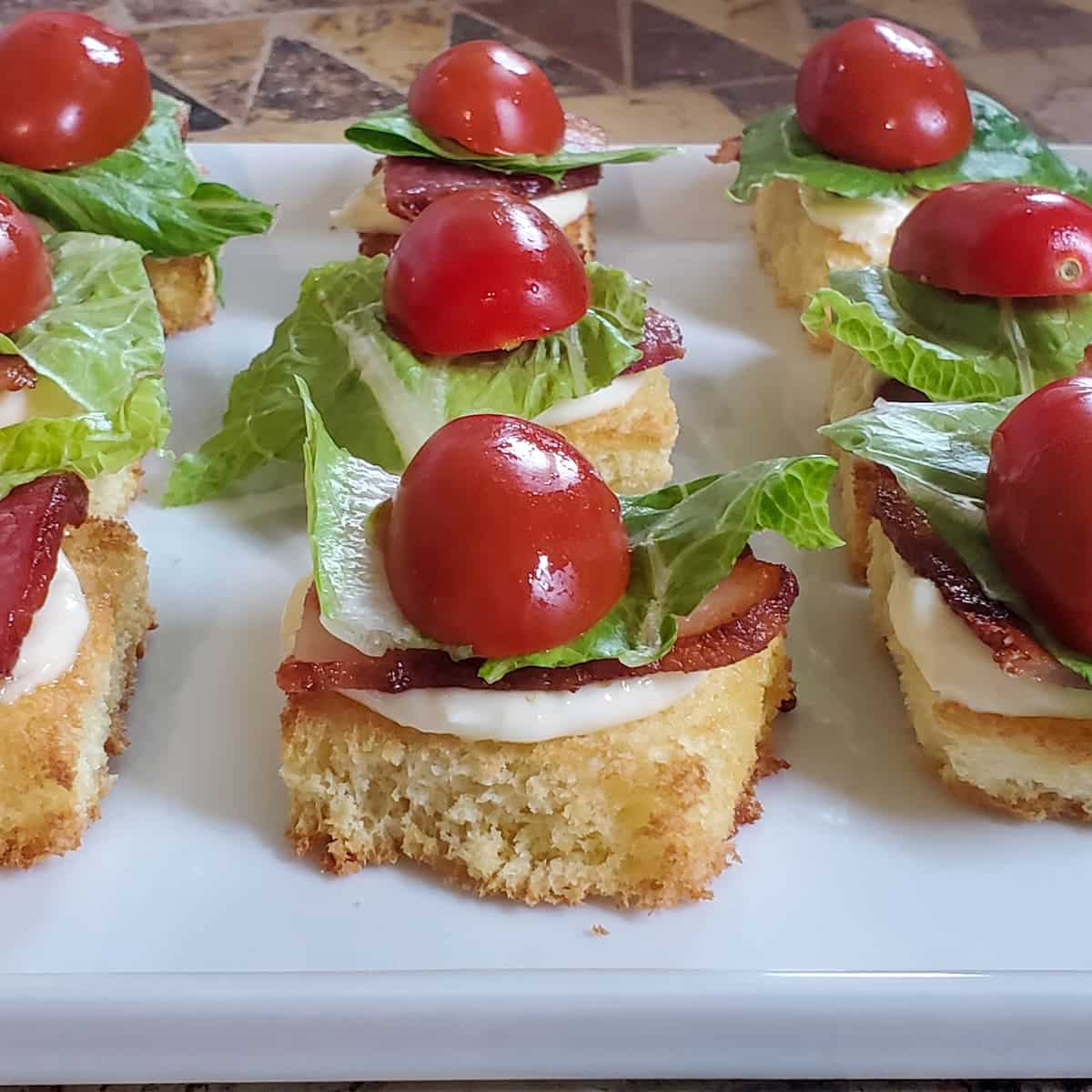 Bite sized BLT appetizer recipe from cleveland cooking.com. Brioche bread, bacon, lettuce and tomato in a bite sized portion!