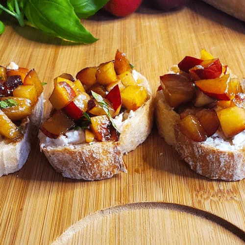 Plum and peach bruschetta with goat cheese and basil. Cleveland cooking.