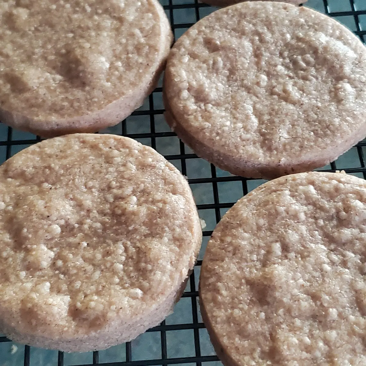 Pumpkin spice shortbread fresh from the oven cooking on a rack.