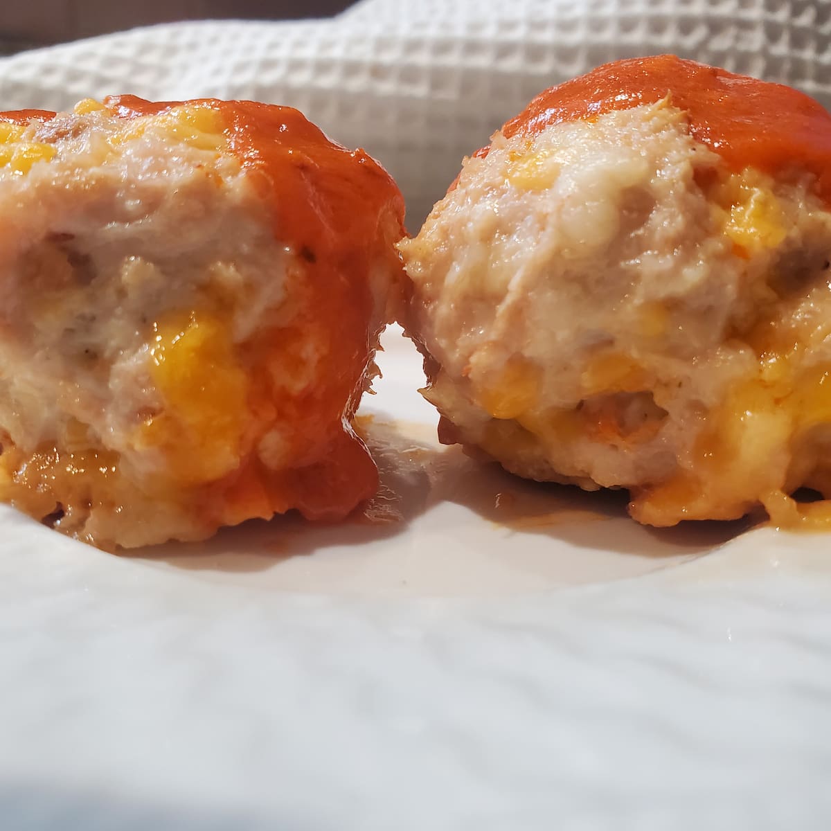 Buffalo Chicken Meatballs fresh from the oven with hot sauce on top. Cleveland Cooking