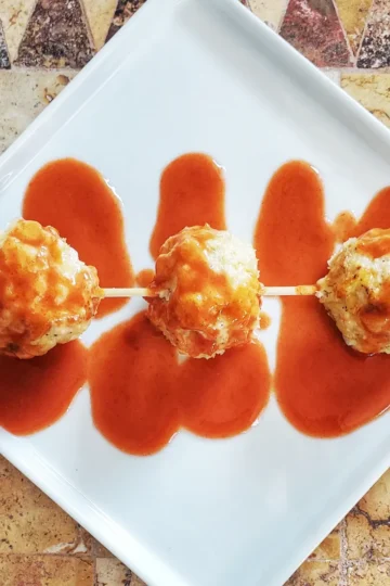 buffalo chicken meatballs Cleveland cooking. cheesy meatballs with buffalo wing sauce.