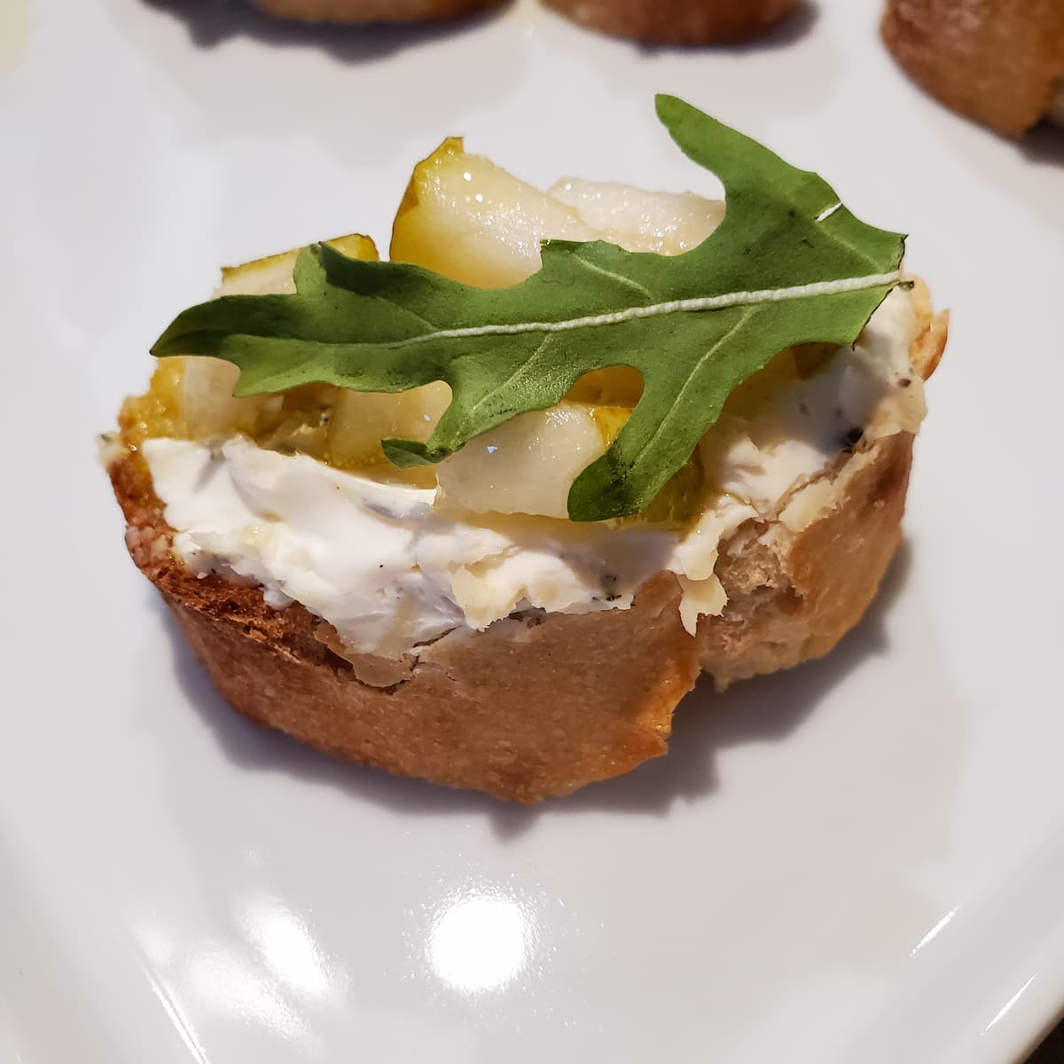 Pear and arugula baguette. A toasted baguette with thyme and black pepper cream cheese, diced pears, and arugula. Recipe from cleveland cooking