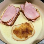 Grilled ham and cheese with fig jam by Cleveland cooking. This picture is during the cooking process showing how to layer the sandwich.