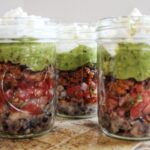 layered taco salad from Cleveland cooking. Refried beans, pico de Gallo,, chorizo, guacamole, sour cream, and queso fresco.