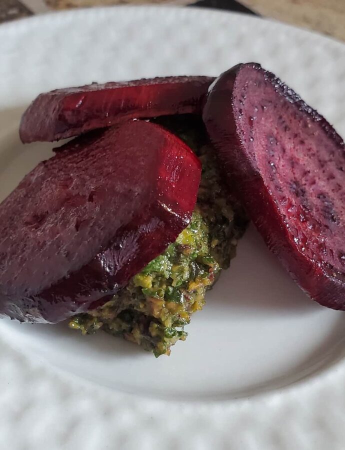 Roasted beets with beets greens pesto. The pesto is made from the greens of the beet stalks. it is made along with garlic and pistachios.