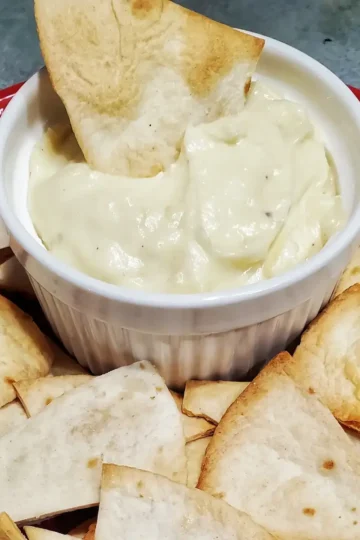 15 minute cheese sauce recipe by Cleveland cooking. Cheese sauce served in a bowl with tortilla chips.