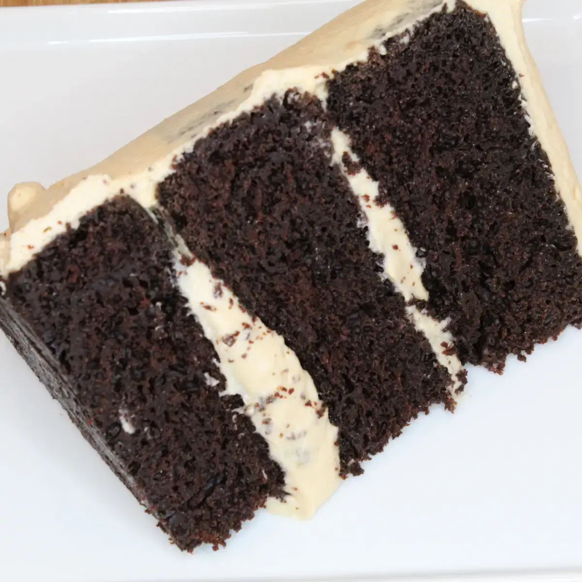 whipped peanut butter frosting from Cleveland cooking. a three tiered chocolate cake with whipped peanut butter frosting.