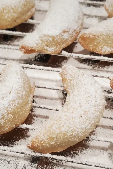 vanillekipferl german vanilla crescents cleveland cooking. German vanilla cookies fresh from the oven and powdered with vanilla powdered sugar.