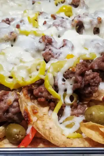 Italian nachos made of tortilla chips, Italian sausage, olives, and cheese fresh from the oven. Cleveland cooking