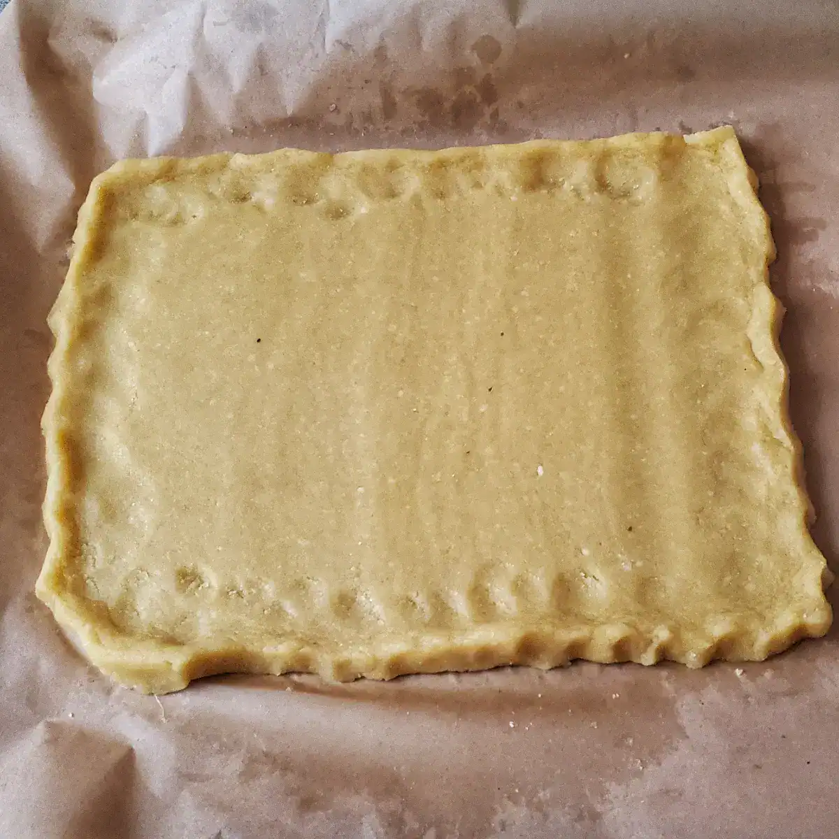 almond flour pizza crust rolled out and ready for blind baking. Cleveland cooking.