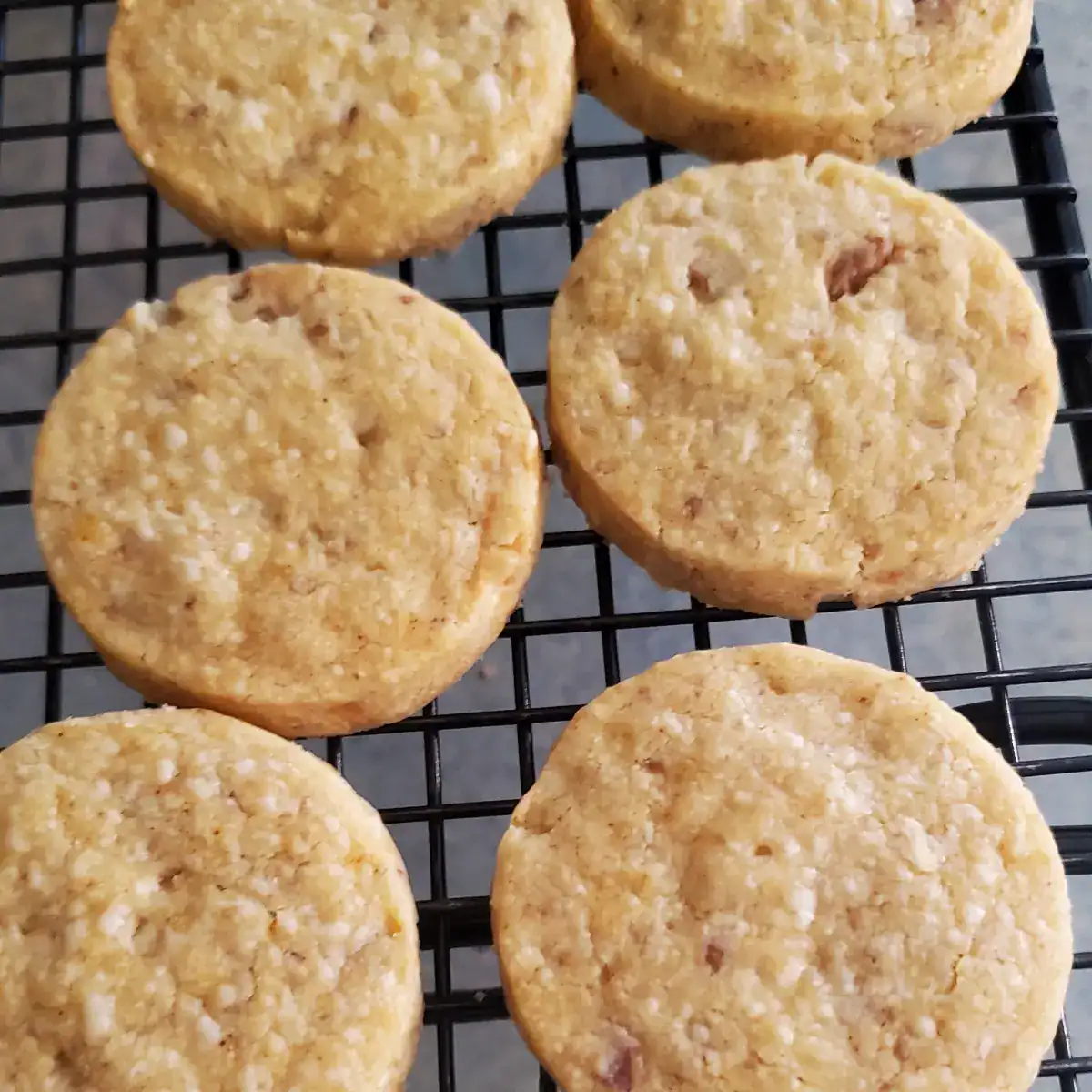 blue cheese and walnut crackers cooling on a black wire cooling rack