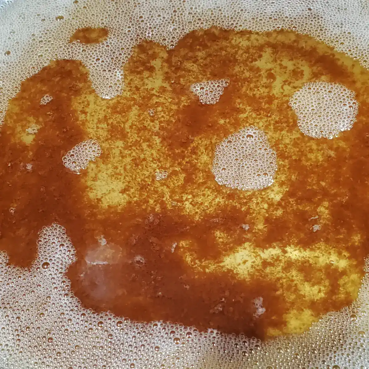Brown butter almost done. brown specks in the bottom of the pan.