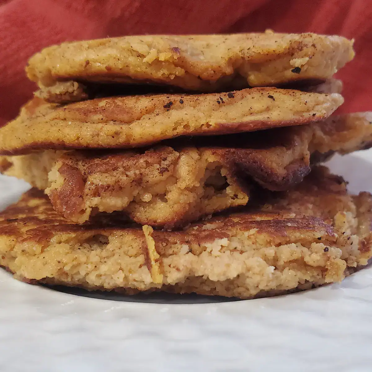 four pumpkin cottage cheese pancakes stacked on top of each other,